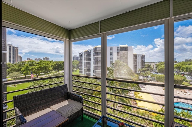 sunroom / solarium featuring a city view