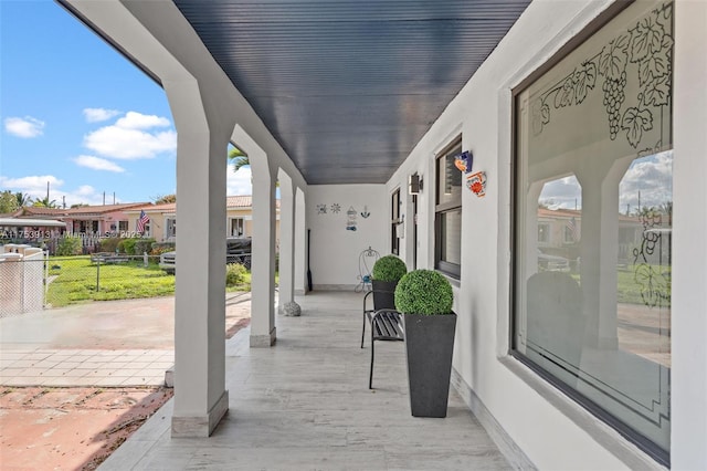 view of patio with covered porch and fence