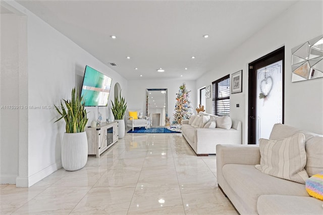 living area featuring recessed lighting, marble finish floor, visible vents, and baseboards