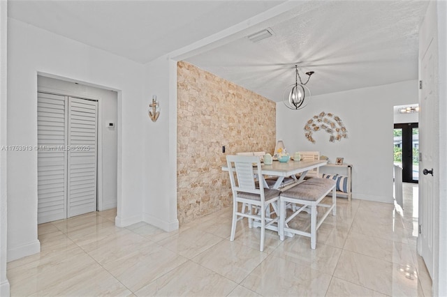 dining space with a textured ceiling, a chandelier, visible vents, baseboards, and french doors