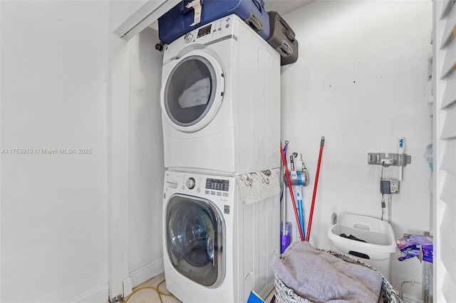 laundry area featuring stacked washing maching and dryer and laundry area