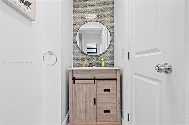 bathroom with decorative backsplash and vanity