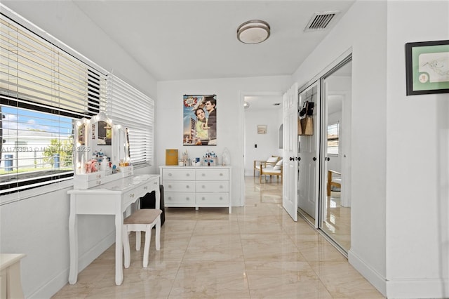 interior space with marble finish floor, visible vents, and baseboards