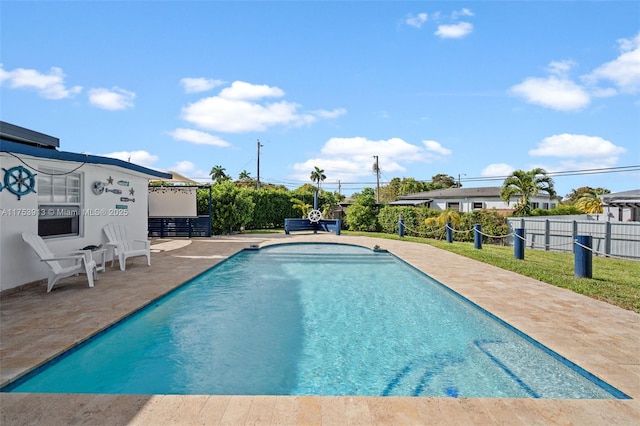 view of swimming pool featuring a fenced in pool, fence, and a patio