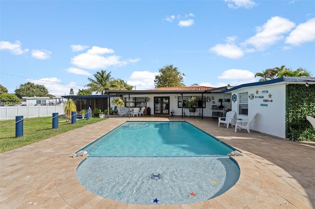 view of pool with a patio, french doors, fence, and a fenced in pool