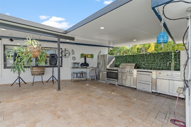 view of patio / terrace with area for grilling, a sink, and an outdoor kitchen