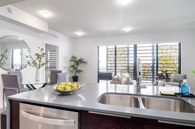 kitchen with plenty of natural light, open floor plan, dishwasher, and a sink