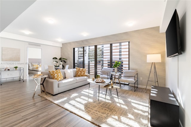 living room with baseboards and wood finished floors