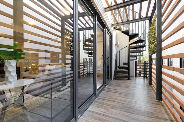 wine cellar featuring expansive windows and wood finished floors