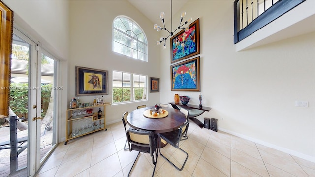 dining area with a healthy amount of sunlight, a high ceiling, and light tile patterned flooring