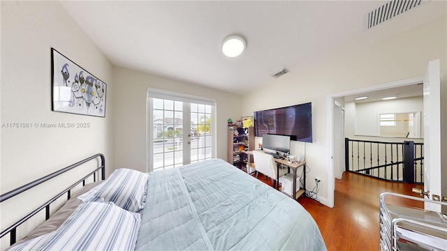 bedroom with french doors, wood finished floors, visible vents, and access to exterior