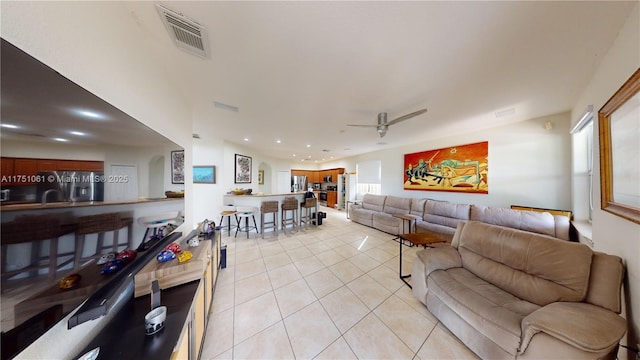 living room with light tile patterned floors, a ceiling fan, visible vents, and recessed lighting