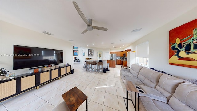 living room with light tile patterned floors, visible vents, a ceiling fan, and recessed lighting