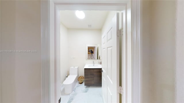 bathroom featuring visible vents, marble finish floor, vanity, and toilet