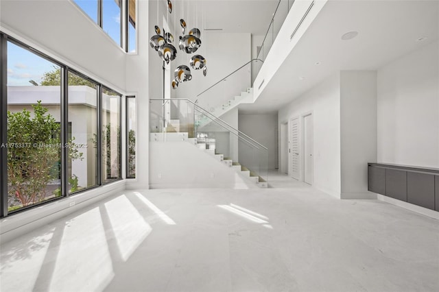 interior space featuring a towering ceiling and stairs