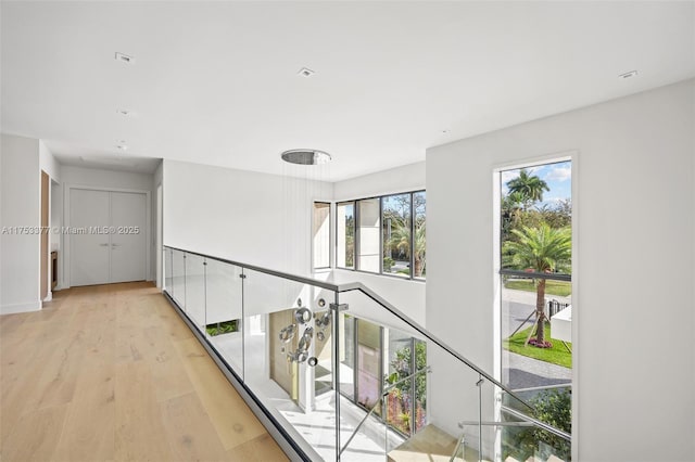 hallway featuring baseboards and light wood-style floors