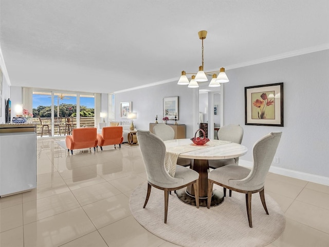 dining area with light tile patterned floors, an inviting chandelier, ornamental molding, a wall of windows, and baseboards