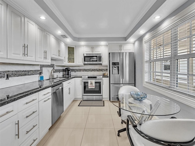 kitchen featuring appliances with stainless steel finishes, a sink, visible vents, and white cabinetry