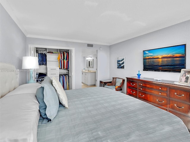 bedroom featuring ensuite bathroom, ornamental molding, a closet, and visible vents