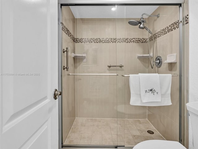 full bath with a shower stall and toilet