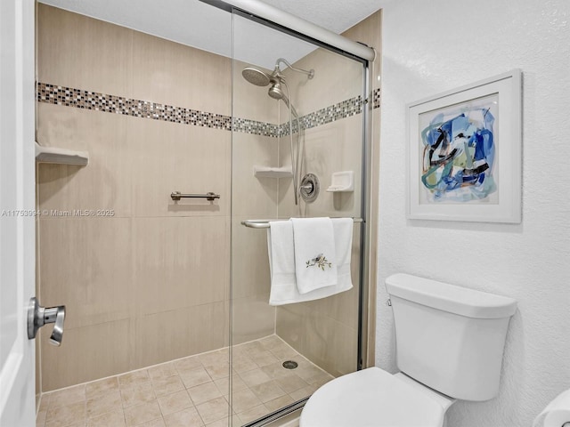 bathroom with toilet and a stall shower