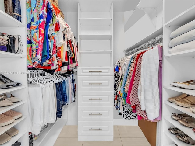 spacious closet with light tile patterned floors