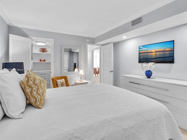 bedroom featuring visible vents and crown molding