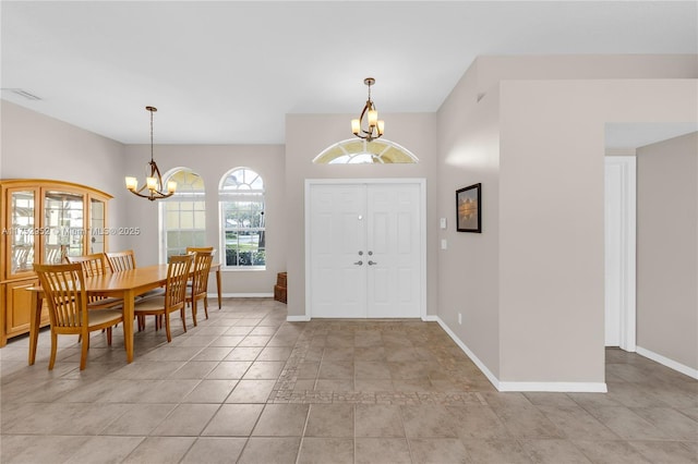 entryway with baseboards, visible vents, and an inviting chandelier