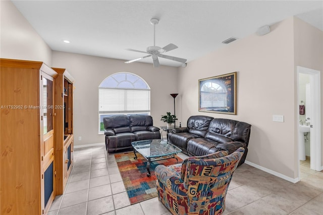 living area featuring visible vents, ceiling fan, baseboards, and light tile patterned floors