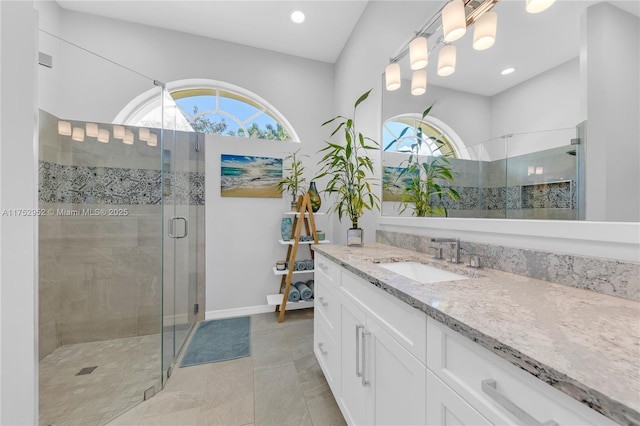 full bath with recessed lighting, a shower stall, vanity, tile patterned flooring, and baseboards