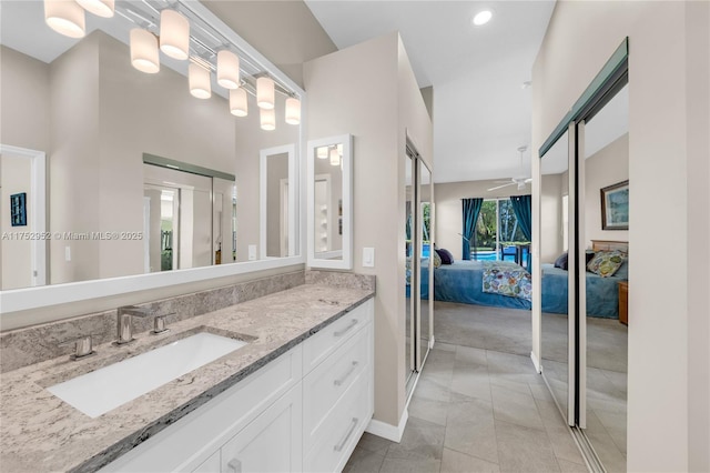 full bathroom featuring recessed lighting, connected bathroom, and vanity