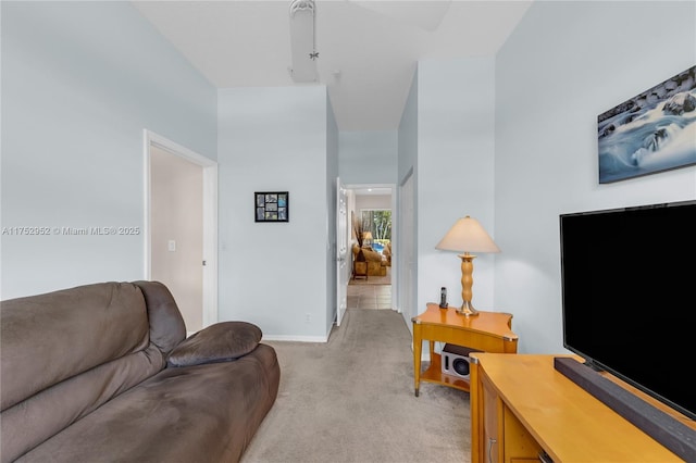 living room with light carpet and baseboards