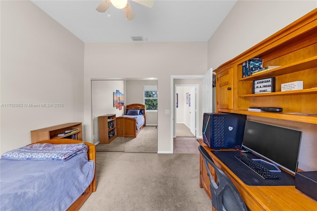 bedroom with baseboards, visible vents, ceiling fan, carpet, and a closet