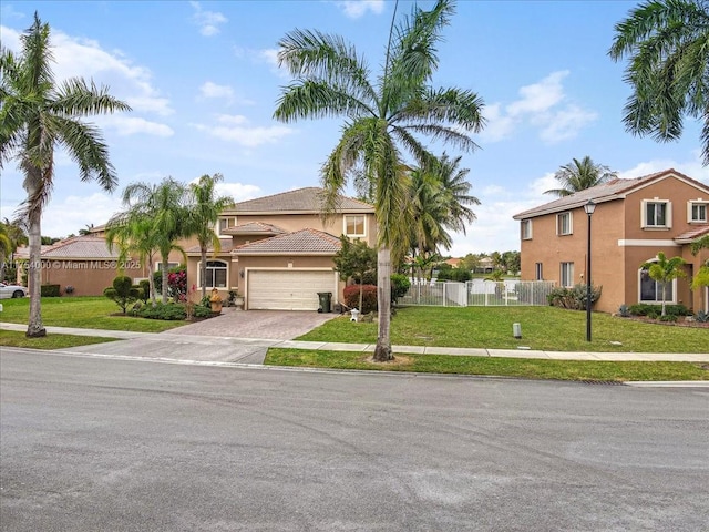 view of front of house with decorative driveway, stucco siding, fence, a garage, and a front lawn