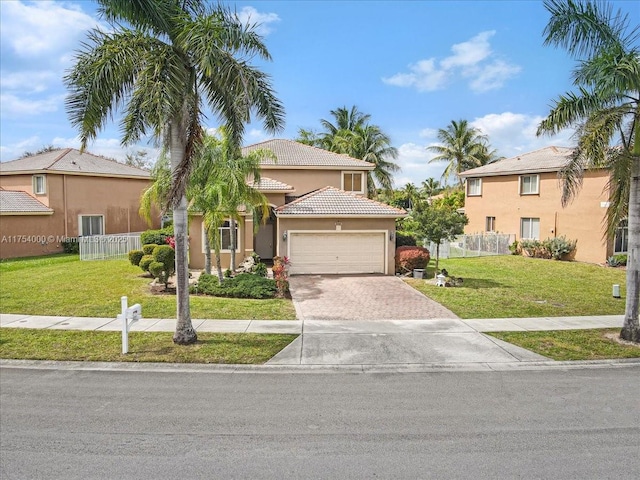 view of front of house with a garage, fence, decorative driveway, stucco siding, and a front lawn