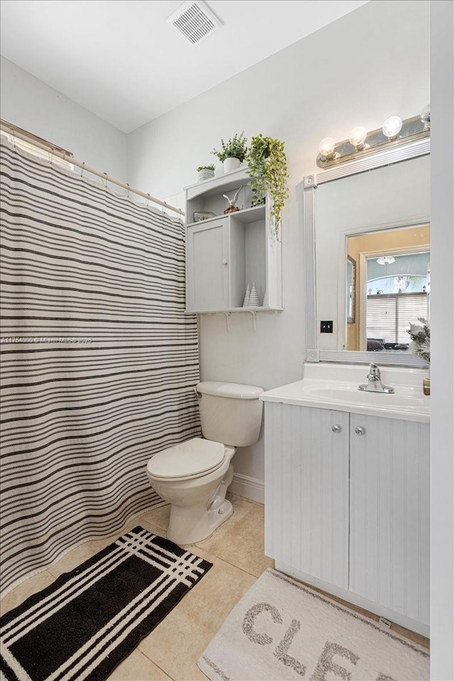 bathroom with visible vents, baseboards, toilet, tile patterned flooring, and vanity