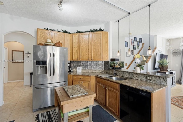 kitchen featuring light tile patterned floors, arched walkways, dishwasher, stainless steel fridge with ice dispenser, and a sink