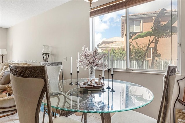 tiled dining area with a textured ceiling