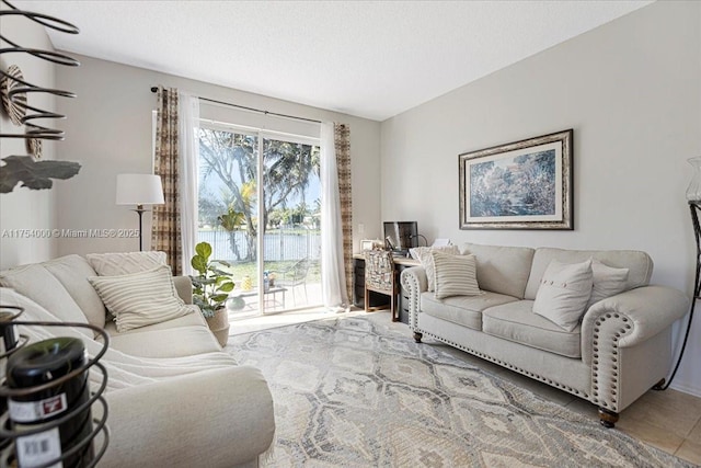 living room with tile patterned flooring and a textured ceiling