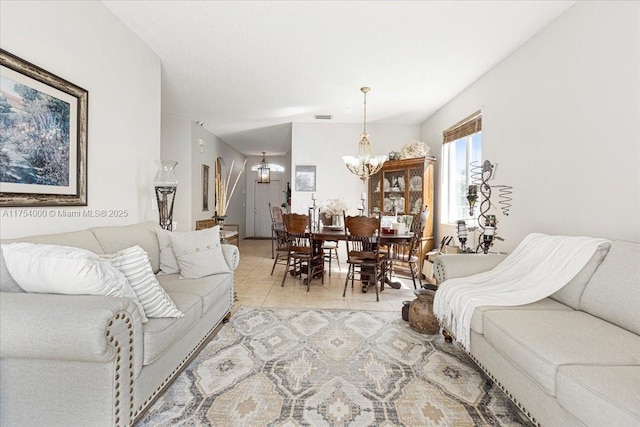 living area featuring an inviting chandelier, visible vents, and light tile patterned flooring