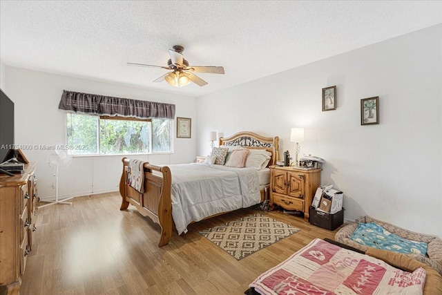 bedroom featuring a ceiling fan, a textured ceiling, and wood finished floors