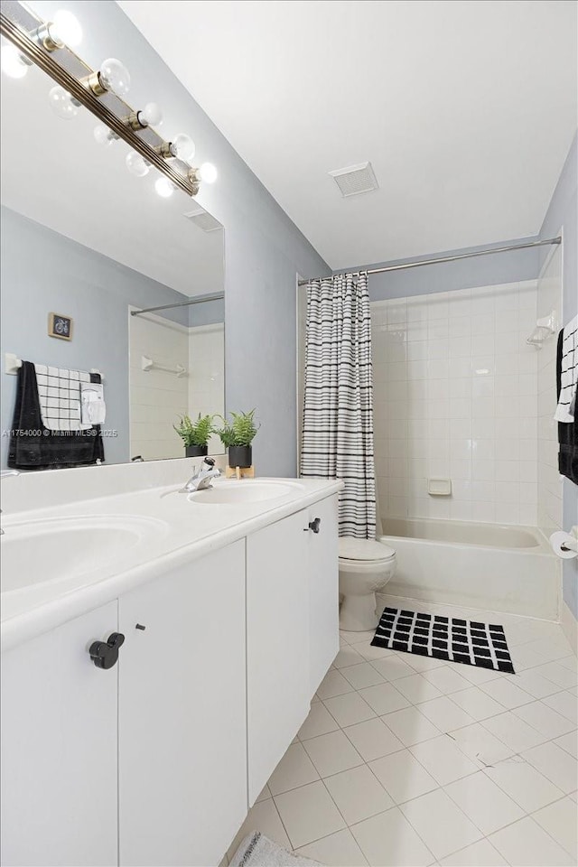 bathroom featuring double vanity, shower / tub combo, toilet, tile patterned flooring, and a sink