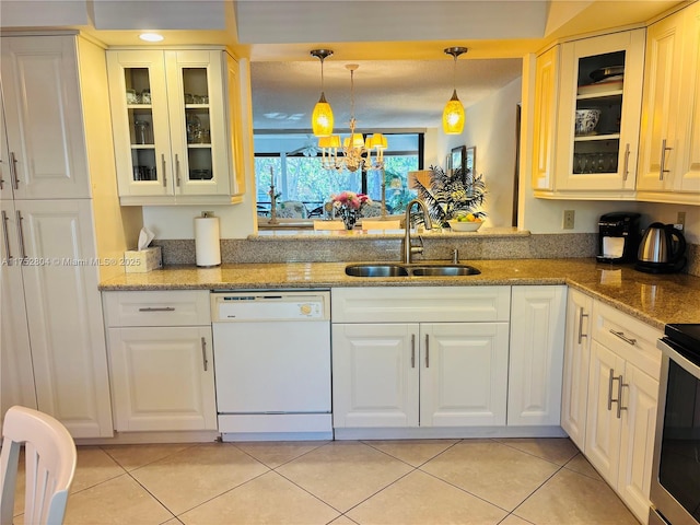 kitchen with hanging light fixtures, light tile patterned floors, white dishwasher, and a sink