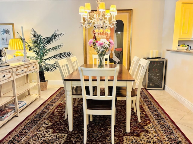 dining room with light tile patterned floors, beverage cooler, baseboards, and an inviting chandelier