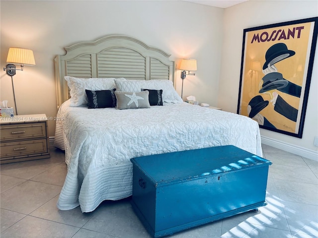 bedroom with baseboards and tile patterned floors