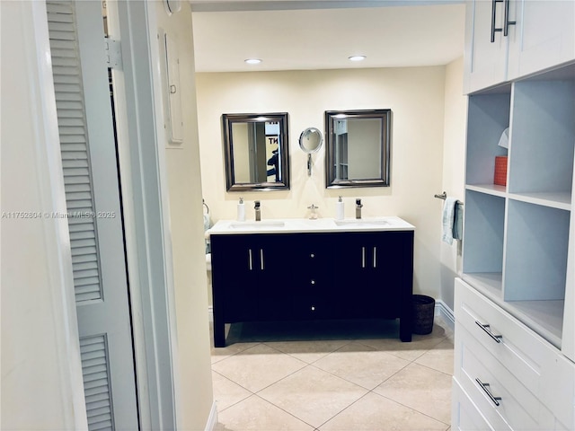 bathroom featuring double vanity, tile patterned flooring, a sink, and recessed lighting