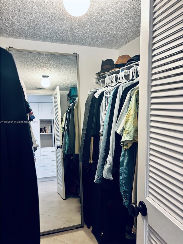 walk in closet featuring tile patterned flooring and visible vents