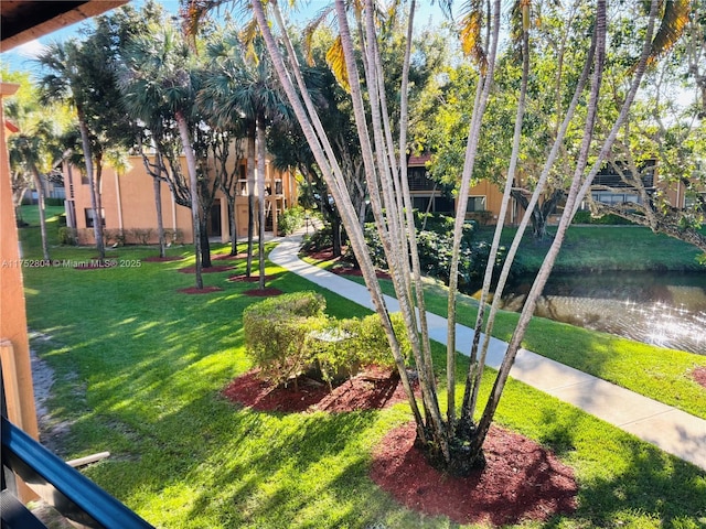 surrounding community featuring a yard and a water view