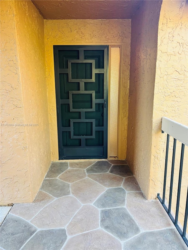 doorway to property with stucco siding