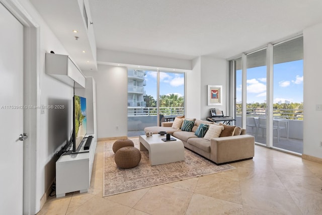 living room with baseboards, a wall of windows, recessed lighting, and a healthy amount of sunlight